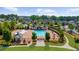 An aerial view displays a community pool area featuring a large pool, sun loungers, and well-maintained landscaping at 10140 Grandview Sq, Duluth, GA 30097