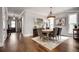 Dining room with hardwood floors, an oval table, neutral walls, and natural light from two windows at 10140 Grandview Sq, Duluth, GA 30097