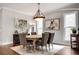 Dining room featuring hardwood floors, an oval table, neutral walls, and natural light from two windows at 10140 Grandview Sq, Duluth, GA 30097