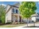 Inviting two-story home with a stone facade, porch, and three-car garage at 10140 Grandview Sq, Duluth, GA 30097