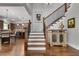 Beautiful foyer with hardwood floors, staircase, and a view into the kitchen at 10140 Grandview Sq, Duluth, GA 30097