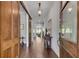 Long foyer with hardwood floors, wooden doors, decorative lighting, and an antique table at 10140 Grandview Sq, Duluth, GA 30097