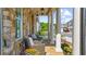 Relaxing front porch with stone floor, classic white columns, wicker furniture and views of the neighborhood at 10140 Grandview Sq, Duluth, GA 30097