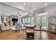 Kitchen features dark brown cabinetry, stone fireplace, a breakfast table, a view of the living room, and hardwood floors at 10140 Grandview Sq, Duluth, GA 30097