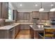 Modern kitchen with stainless steel appliances, an island, and a beautiful backsplash at 10140 Grandview Sq, Duluth, GA 30097