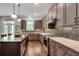 Spacious kitchen features stainless appliances, ample counter space and view to outdoor patio at 10140 Grandview Sq, Duluth, GA 30097
