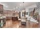 Kitchen featuring dark brown cabinetry, island, a breakfast table, and access to the staircase at 10140 Grandview Sq, Duluth, GA 30097