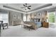 Spacious main bedroom boasts tray ceilings, plush carpeting, and generous natural light from large windows at 10140 Grandview Sq, Duluth, GA 30097