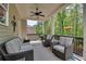 Cozy covered porch with comfortable seating, ceiling fan, and a view of the lush greenery at 10140 Grandview Sq, Duluth, GA 30097