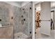 Modern frameless glass shower with sleek hardware and stone tile, connecting to a walk-in closet at 10140 Grandview Sq, Duluth, GA 30097