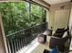 Outdoor balcony with patio furniture overlooking a wooded area, offering privacy at 3047 Lenox Ne Rd # 2105, Atlanta, GA 30324