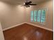 Bright bedroom with plantation shutters, hardwood floors, and a ceiling fan at 3047 Lenox Ne Rd # 2105, Atlanta, GA 30324
