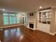 Inviting living room featuring a fireplace, built-in shelving, and large windows at 3047 Lenox Ne Rd # 2105, Atlanta, GA 30324