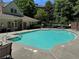 Community pool surrounded by lounge chairs and umbrellas at 3047 Lenox Ne Rd # 2105, Atlanta, GA 30324