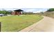 Spacious lawn area of the amphitheater with a stage and sidewalks at 727 Hammond Dr, Woodstock, GA 30188