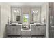 Elegant bathroom with double vanity, vessel sinks, decorative tile floor, and natural light from a window at 727 Hammond Dr, Woodstock, GA 30188