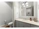 Well-lit powder room featuring stylish vanity, granite countertop, and modern fixtures at 727 Hammond Dr, Woodstock, GA 30188