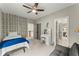 Bedroom featuring a ceiling fan, unique ivy wallpaper and a view of the landing and hallway at 727 Hammond Dr, Woodstock, GA 30188