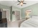 Cozy bedroom with neutral walls, ceiling fan and a view of the closet through the doorway at 727 Hammond Dr, Woodstock, GA 30188