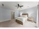 Bedroom with light blue walls, ceiling fan, and neutral carpet at 727 Hammond Dr, Woodstock, GA 30188