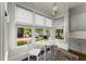 Charming breakfast nook with great natural light, a round table, and views of the landscaped yard at 727 Hammond Dr, Woodstock, GA 30188