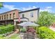 Charming home with manicured yard and patio featuring an umbrella-covered table set at 727 Hammond Dr, Woodstock, GA 30188