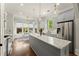 Bright kitchen features stainless appliances, a center island with granite counters and pendant lighting at 727 Hammond Dr, Woodstock, GA 30188