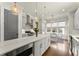 Bright kitchen features stainless appliances, a center island with granite counters and pendant lighting at 727 Hammond Dr, Woodstock, GA 30188