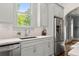 Bright kitchen features stainless appliances, white backsplash, and granite counters at 727 Hammond Dr, Woodstock, GA 30188