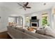 Comfortable living room featuring a ceiling fan, fireplace, and an open layout at 727 Hammond Dr, Woodstock, GA 30188
