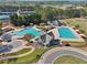 Aerial view showcases the community pools, waterslides, and meticulously landscaped surroundings, ideal for recreation at 8640 Amsbury Way, Cumming, GA 30041