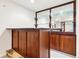 Classic wet bar featuring glass shelves and wooden cabinetry at 8640 Amsbury Way, Cumming, GA 30041
