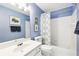 Inviting bathroom with vanity, tiled shower, and framed art at 8640 Amsbury Way, Cumming, GA 30041