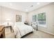 Bright bedroom featuring a large window with backyard views at 8640 Amsbury Way, Cumming, GA 30041
