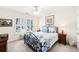Cozy bedroom with shuttered windows, a decorative bed frame, and coordinating side tables at 8640 Amsbury Way, Cumming, GA 30041