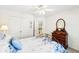 Bright bedroom with ample natural light, ceiling fan, and decorative bedspread at 8640 Amsbury Way, Cumming, GA 30041