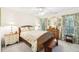 Comfortable bedroom featuring a wicker bed frame, floral patterned curtains, and coordinated furnishings at 8640 Amsbury Way, Cumming, GA 30041