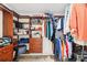 Organized walk-in closet featuring built-in shelving, drawers, and hanging rods for efficient storage at 8640 Amsbury Way, Cumming, GA 30041