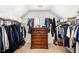 Spacious closet with shelving, hanging racks, and a central dresser, providing ample storage space at 8640 Amsbury Way, Cumming, GA 30041