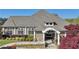 A charming, well-maintained clubhouse surrounded by lush landscaping, perfect for gatherings and community events at 8640 Amsbury Way, Cumming, GA 30041