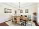 Formal dining room with decorative ceiling, wainscoting, and a chandelier at 8640 Amsbury Way, Cumming, GA 30041