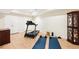 Basement exercise room complete with a treadmill and yoga mats at 8640 Amsbury Way, Cumming, GA 30041