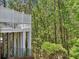 Two-story home exterior featuring a spacious balcony with decorative white lattice railings and wooded backyard views at 8640 Amsbury Way, Cumming, GA 30041