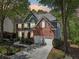 Two-story home exterior featuring a well-manicured lawn, a two-car garage, and mature trees in the front yard at 8640 Amsbury Way, Cumming, GA 30041