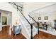 Open foyer with hardwood floors, staircase, with dining room visible in the background at 8640 Amsbury Way, Cumming, GA 30041