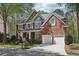 Charming two-story brick home with a well-manicured lawn, professional landscaping, and attached two car garage at 8640 Amsbury Way, Cumming, GA 30041