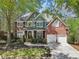 Charming brick home featuring a two-car garage and beautifully landscaped front yard at 8640 Amsbury Way, Cumming, GA 30041