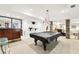 Large game room featuring a pool table, bar area, and stone support beams at 8640 Amsbury Way, Cumming, GA 30041