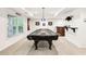 Game room with a pool table and a built-in bar area, great for entertaining at 8640 Amsbury Way, Cumming, GA 30041