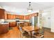 Warm kitchen with wooden cabinets, stainless steel appliances, and a cozy breakfast nook at 8640 Amsbury Way, Cumming, GA 30041
